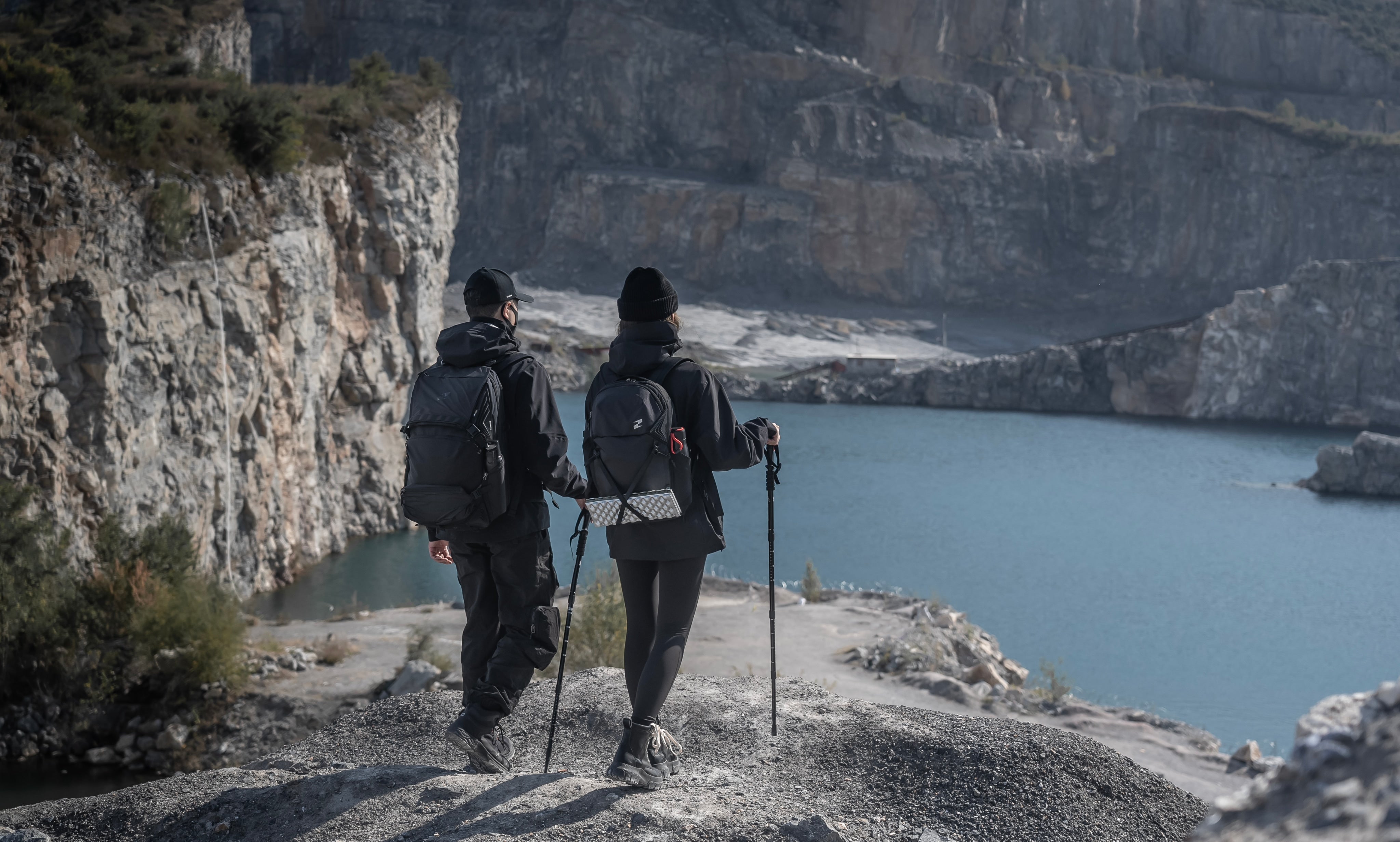Two explorers overlooking a mountain lake